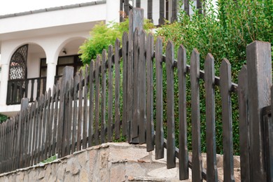 Low wooden shabby fence near building outdoors