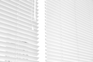 Window with modern horizontal blinds indoors. Space for text