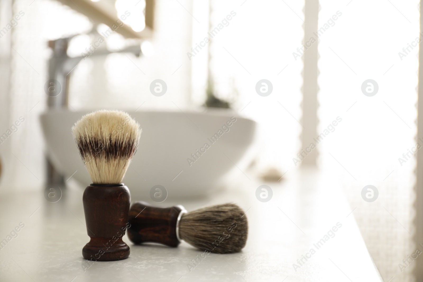 Photo of Pair of shaving brushes in modern bathroom interior