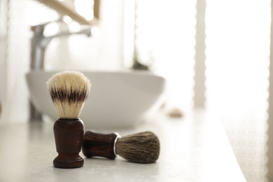 Photo of Pair of shaving brushes in modern bathroom interior