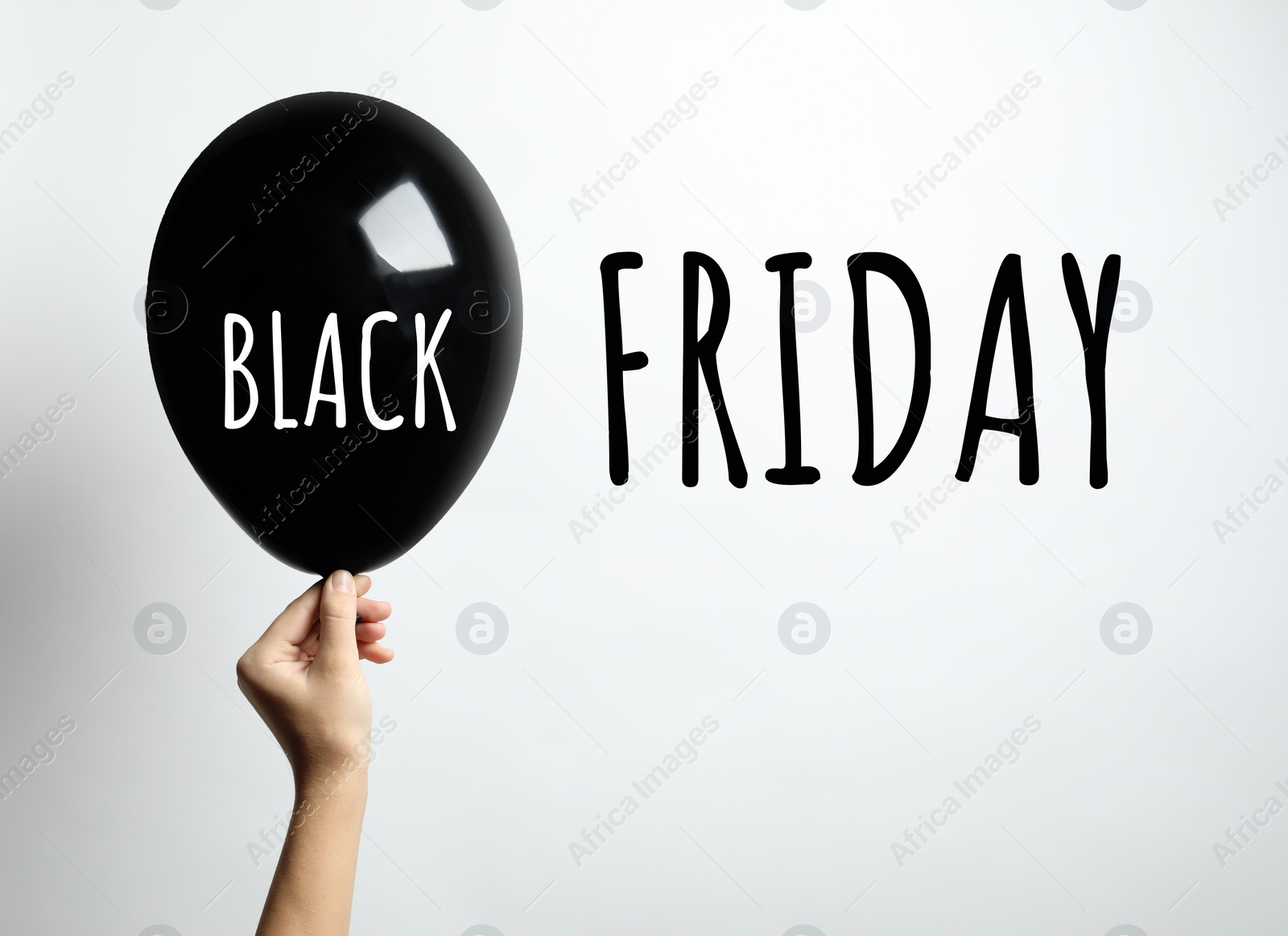 Image of Black Friday concept. Woman holding balloon on white background, closeup