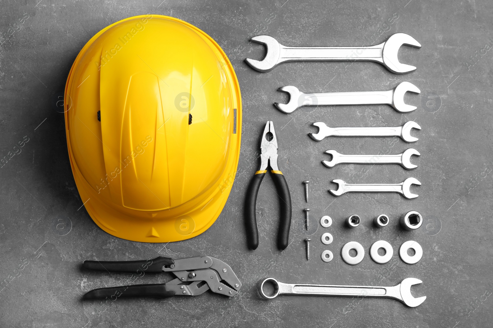 Photo of Flat lay composition with different construction tools on grey background