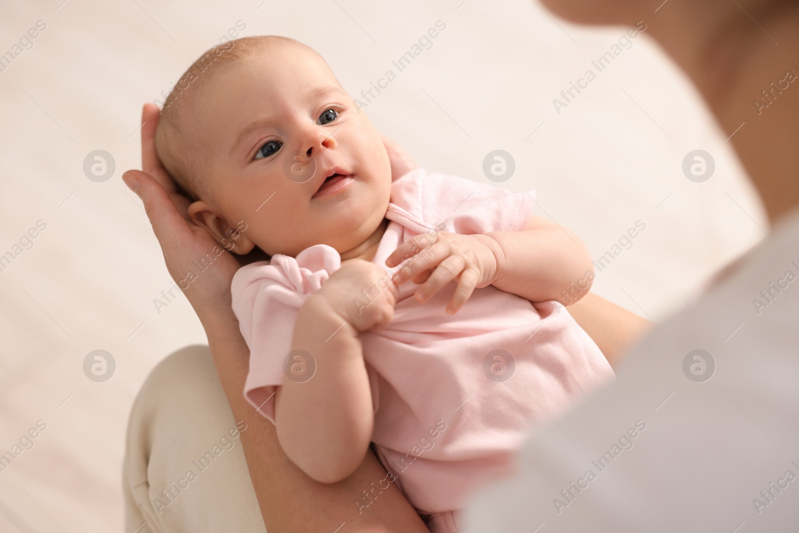 Photo of Mother with her cute little baby at home