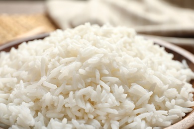 Plate of tasty cooked white rice on table, closeup