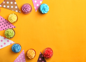 Photo of Delicious birthday cupcakes on color background