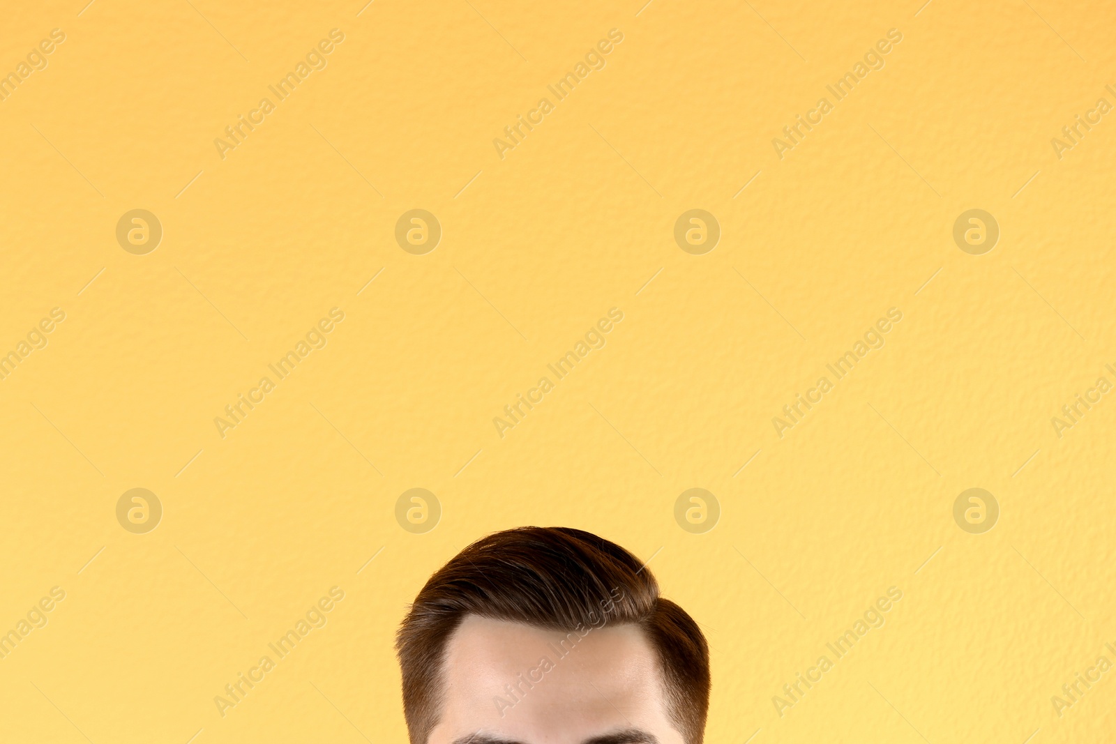 Photo of Man with beautiful hair on color background, closeup