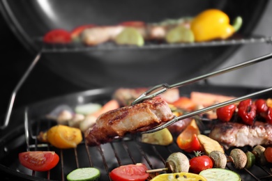 Photo of Cooking delicious meat and vegetables on barbecue grill, closeup