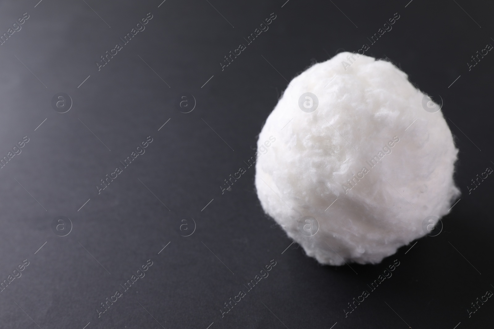 Photo of Ball of clean cotton wool on grey background, space for text