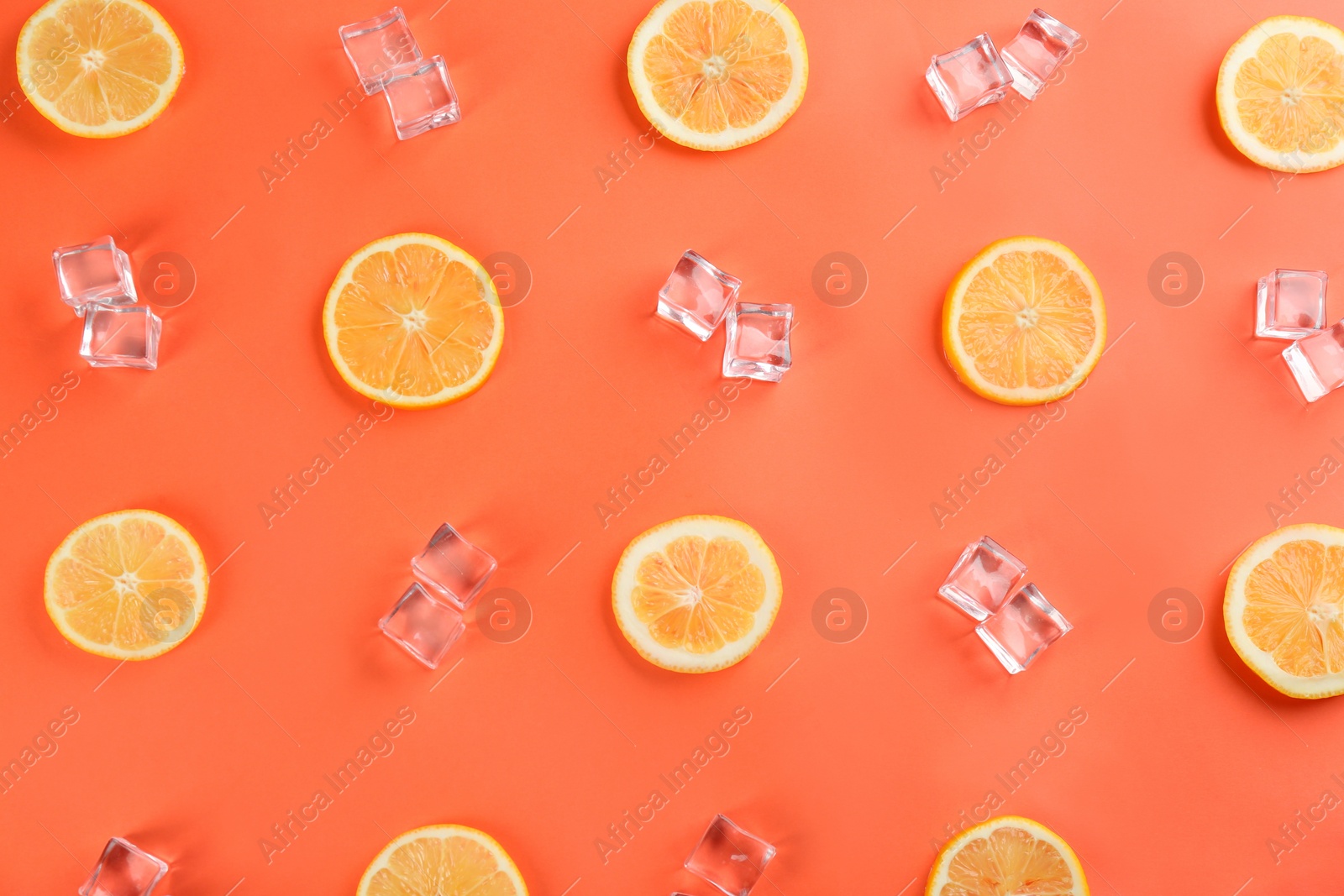 Photo of Lemonade layout with juicy lemon slices and ice cubes on coral background, top view