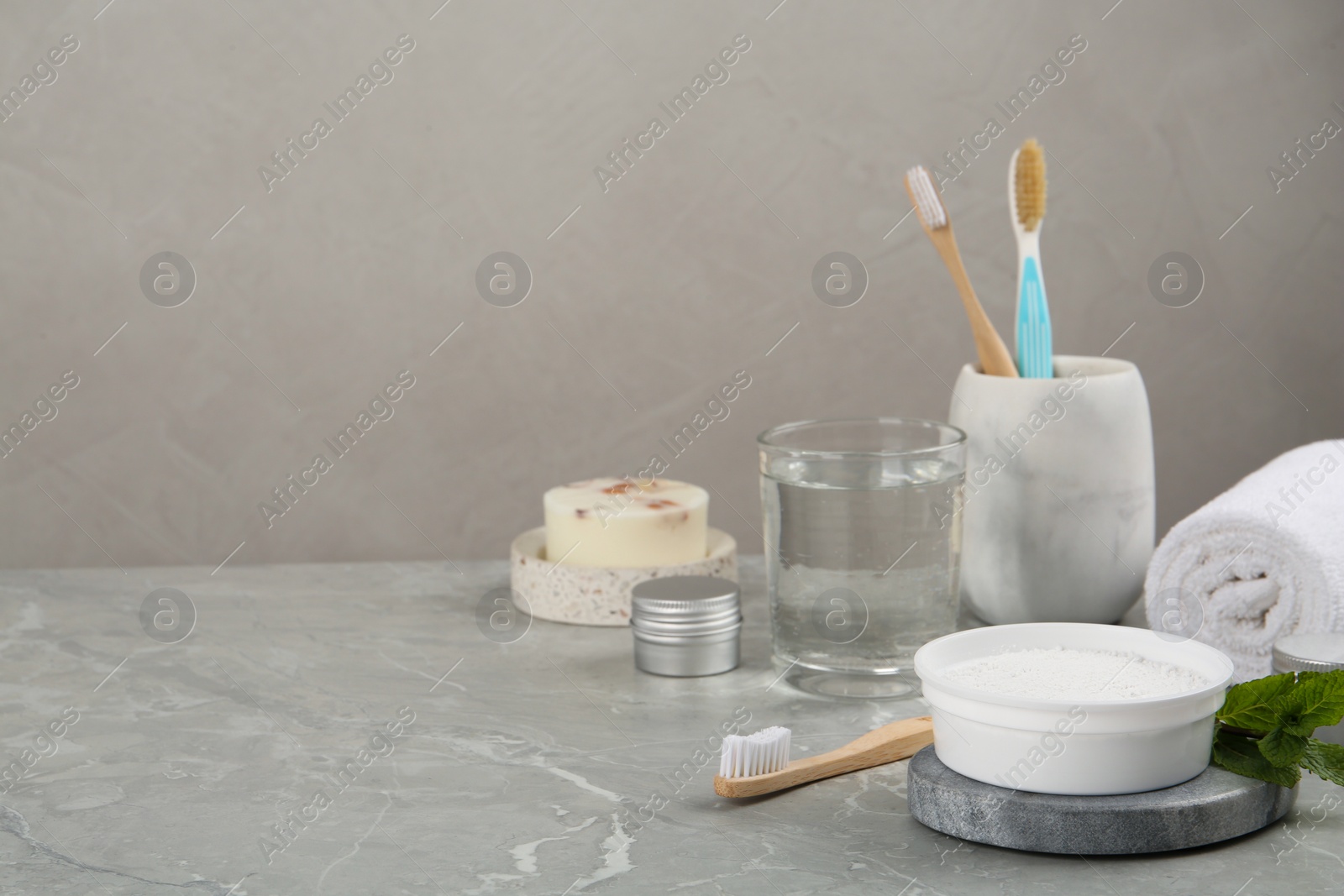 Photo of Composition with tooth powder on light grey marble table, space for text