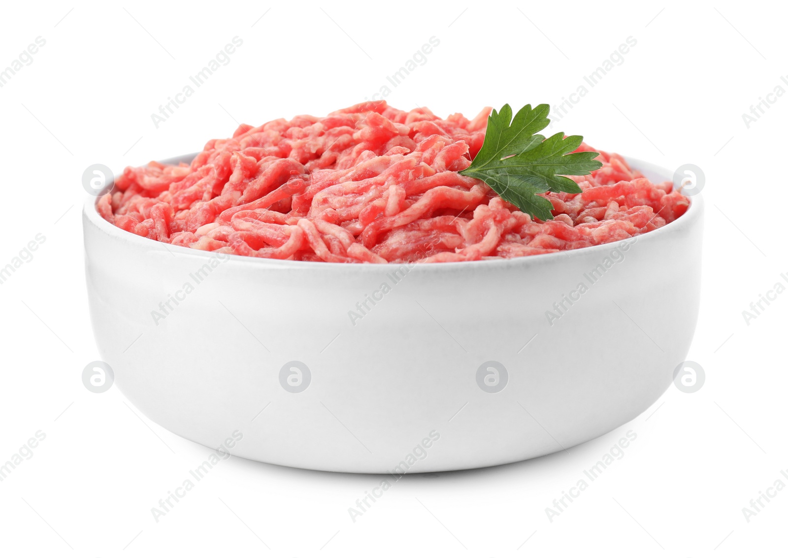 Photo of Raw ground meat and parsley in bowl isolated on white