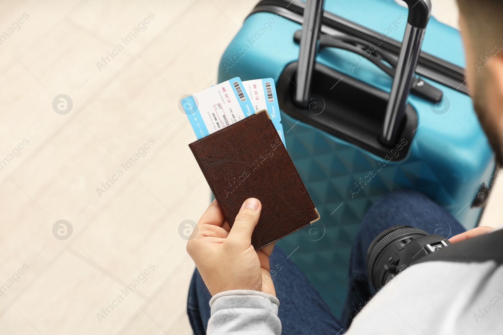 Photo of Man with suitcase, camera, passport and tickets, closeup. Space for text