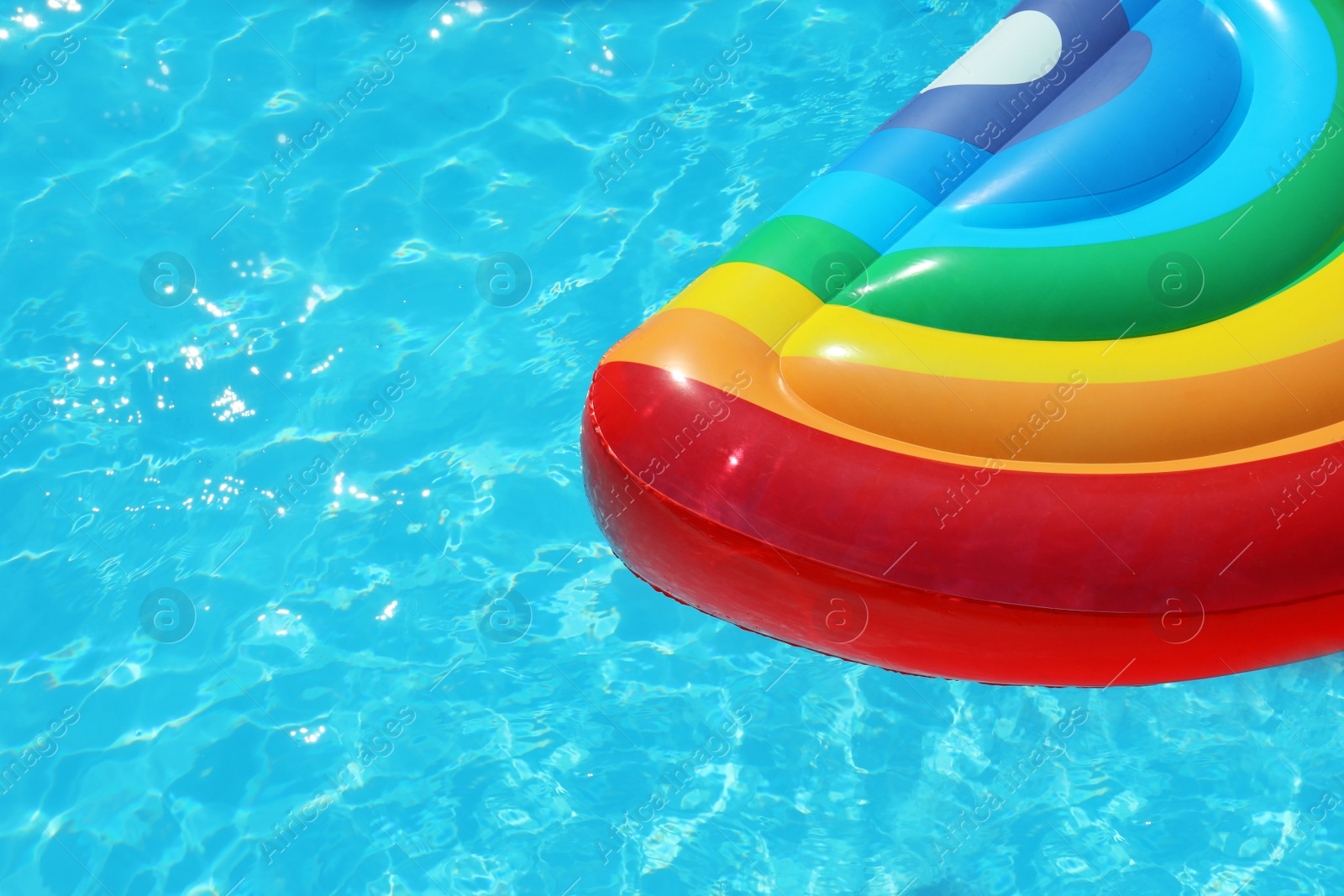 Photo of Inflatable mattress floating in swimming pool on sunny day