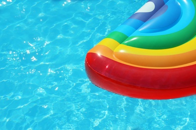 Photo of Inflatable mattress floating in swimming pool on sunny day