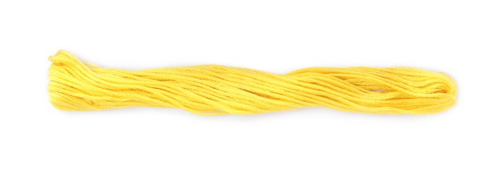 Photo of Bright yellow embroidery thread on white background