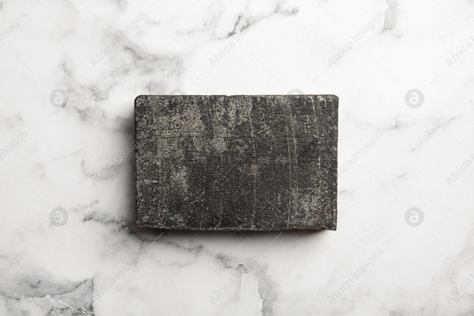 Photo of Hand made soap bar on marble background, top view