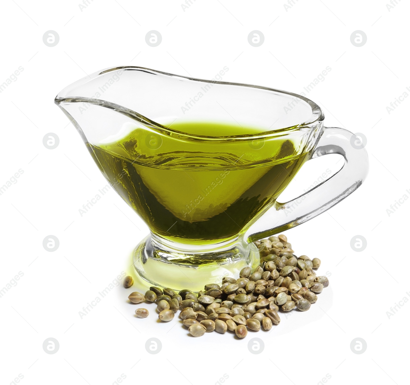 Photo of Gravy boat with hemp oil and seeds on white background