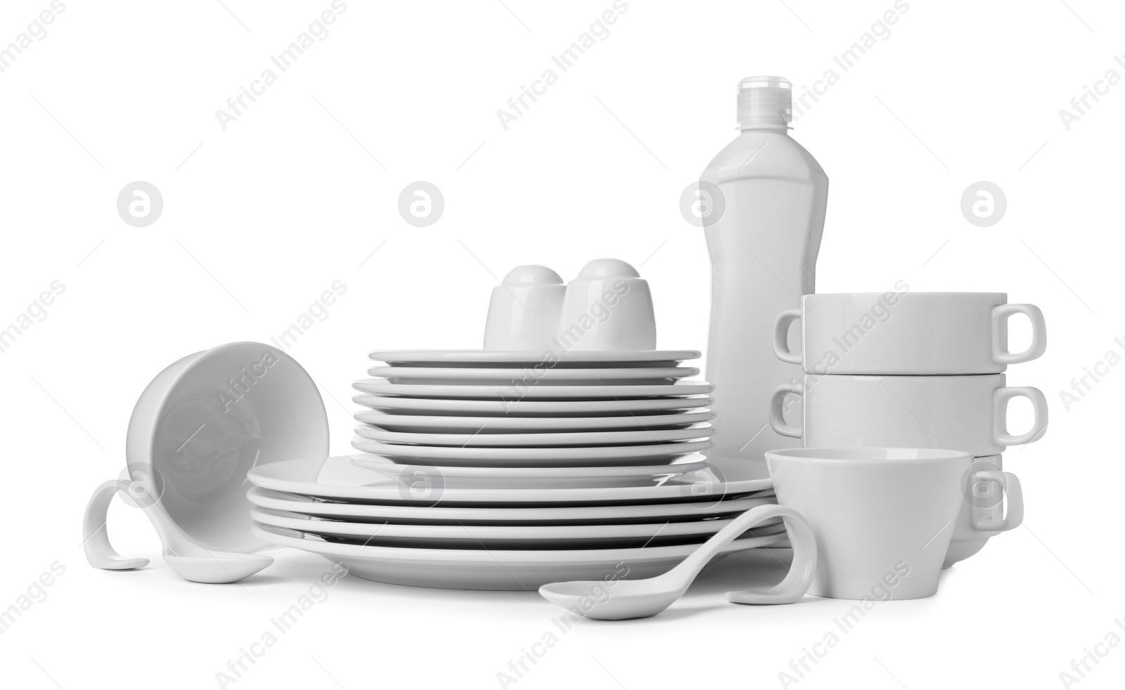 Photo of Clean dishware and bottle of detergent isolated on white