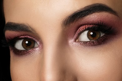 Photo of Young woman with evening makeup, closeup. Eye shadow product