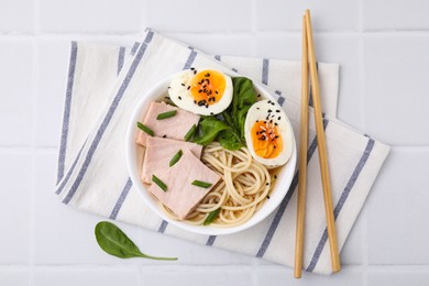 Photo of Delicious ramen with meat on white tiled table, flat lay. Noodle soup