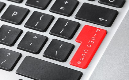 Image of Red button with phrase Promo Code on computer keyboard, closeup view