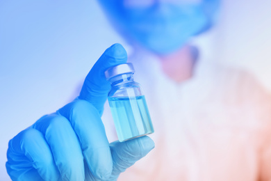 Image of Doctor holding vial with medication, closeup. Vaccination and immunization