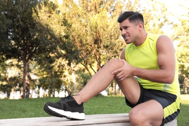 Photo of Man in sportswear having knee problems in park