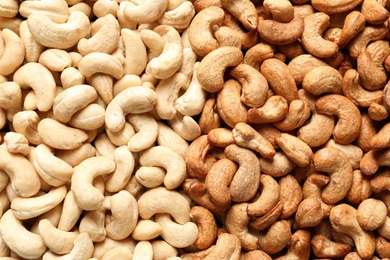 Tasty cashew nuts as background, top view