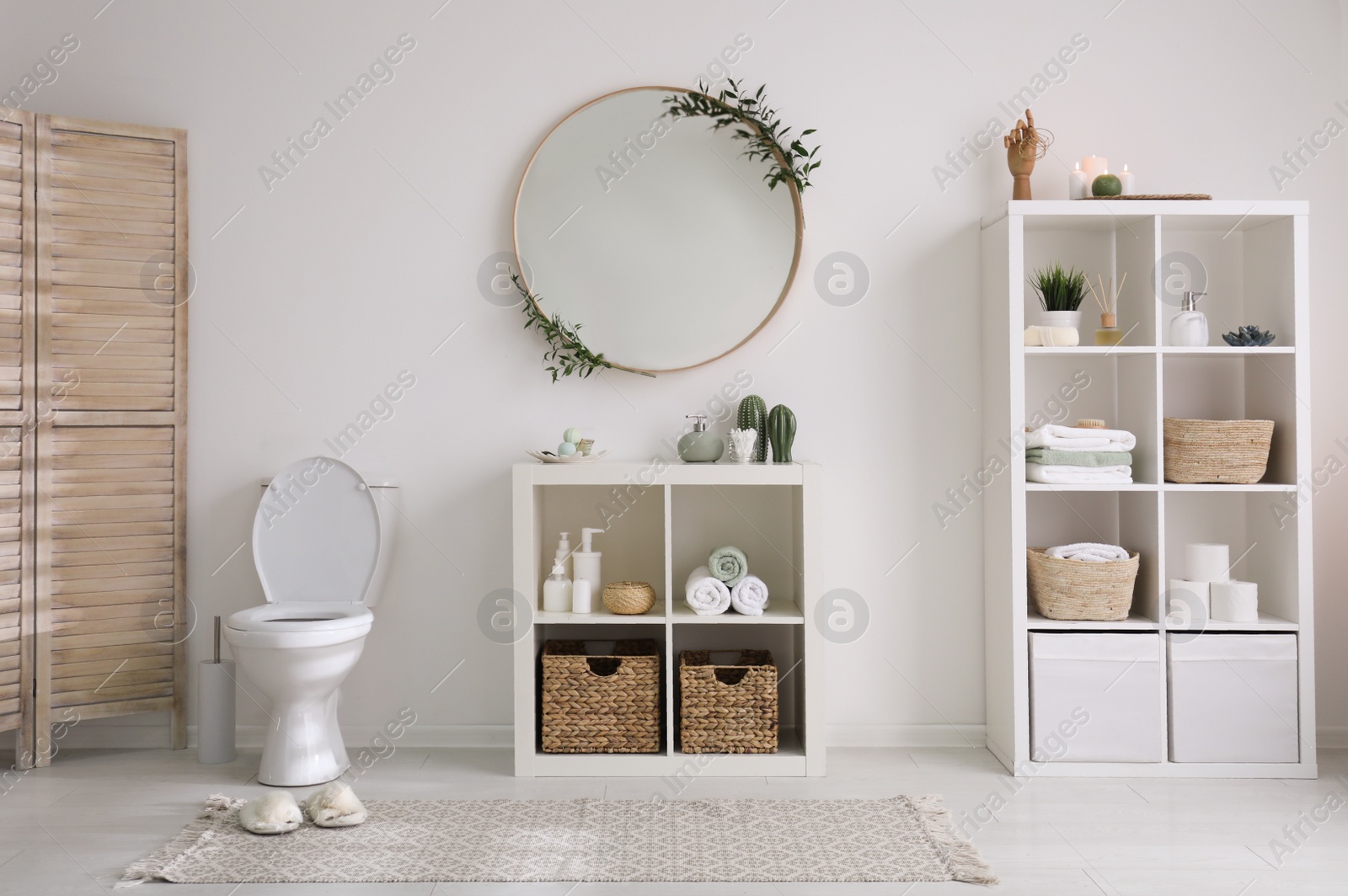 Photo of Interior of modern bathroom with round mirror