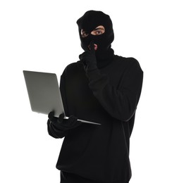 Photo of Thief in balaclava with laptop showing hush gesture on white background