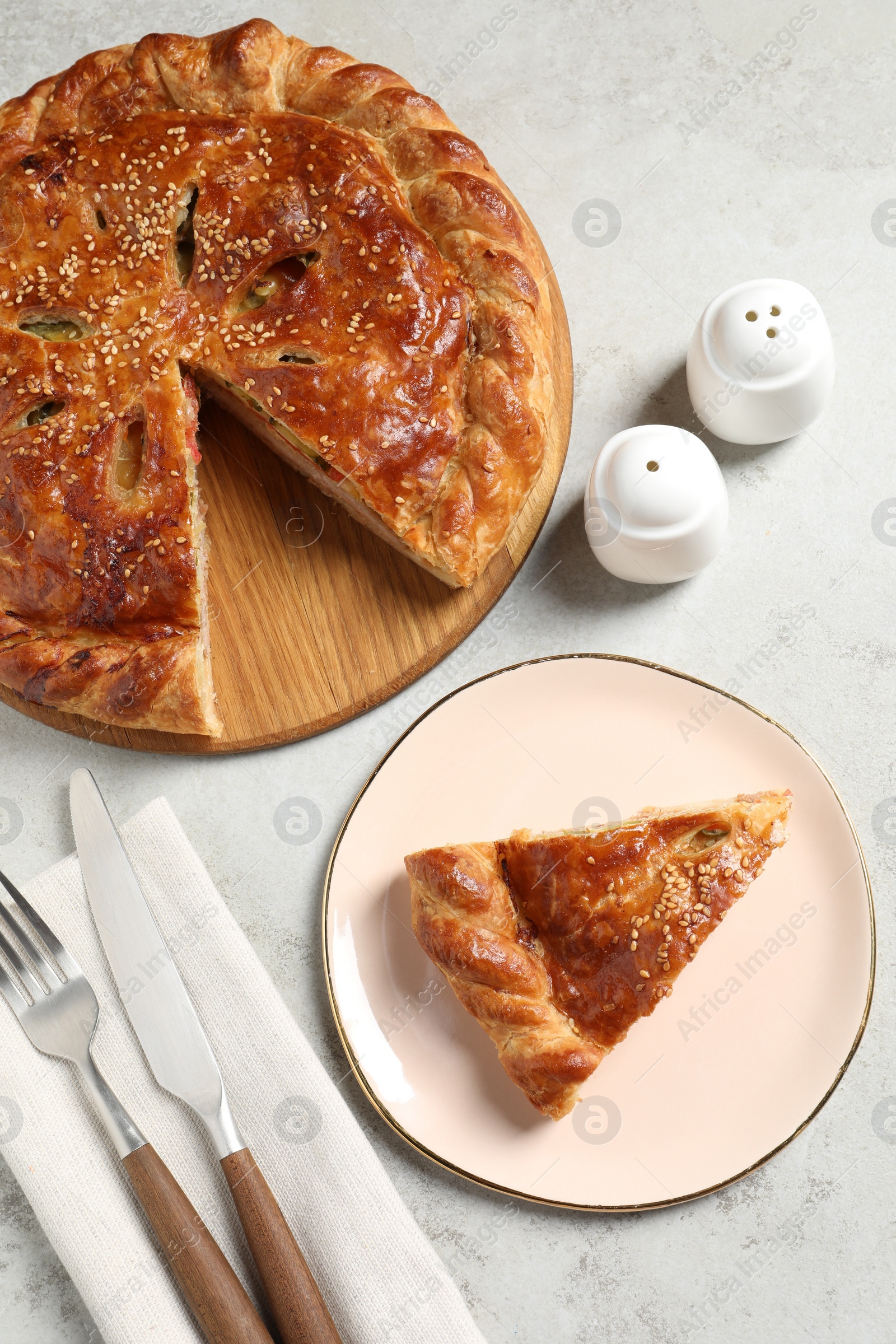 Photo of Tasty homemade pie served on light grey table, flat lay