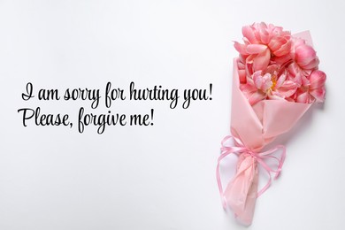 Sincere sorry message and bouquet of pink flowers on white background, top view