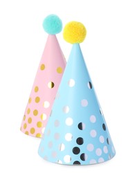 Photo of Two colorful party hats with pompoms isolated on white