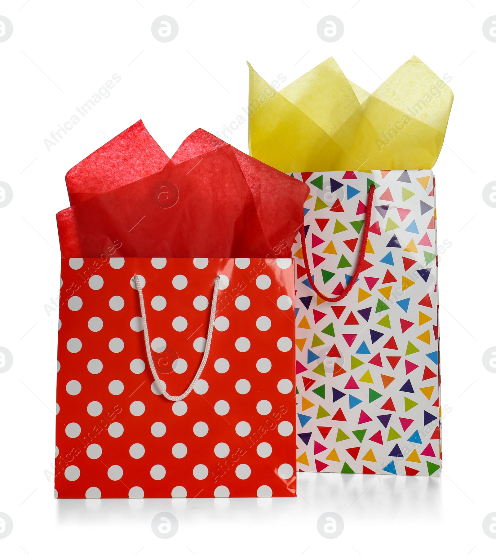 Photo of Gift bags with paper on white background