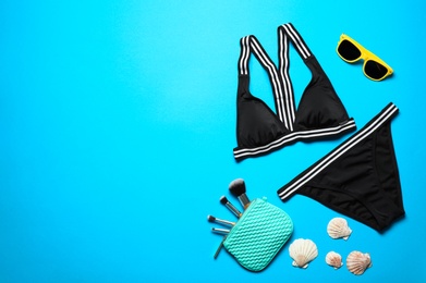 Photo of Flat lay composition with bikini and accessories on color background