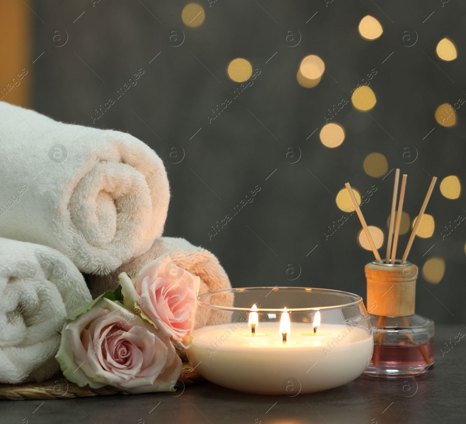 Photo of Composition with different spa products and rose flowers on grey table