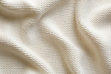 Photo of Beautiful white knitted fabric as background, top view