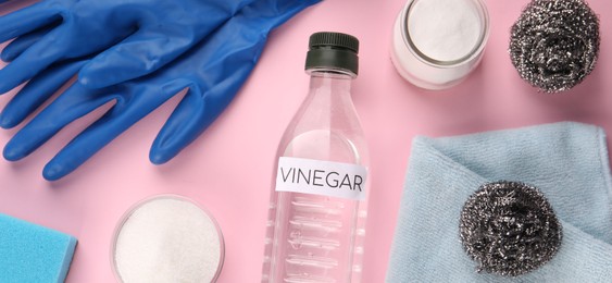 Photo of Eco friendly natural cleaners. Flat lay composition with bottle of vinegar on pink background