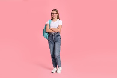 Photo of Teenage girl with backpack on pink background