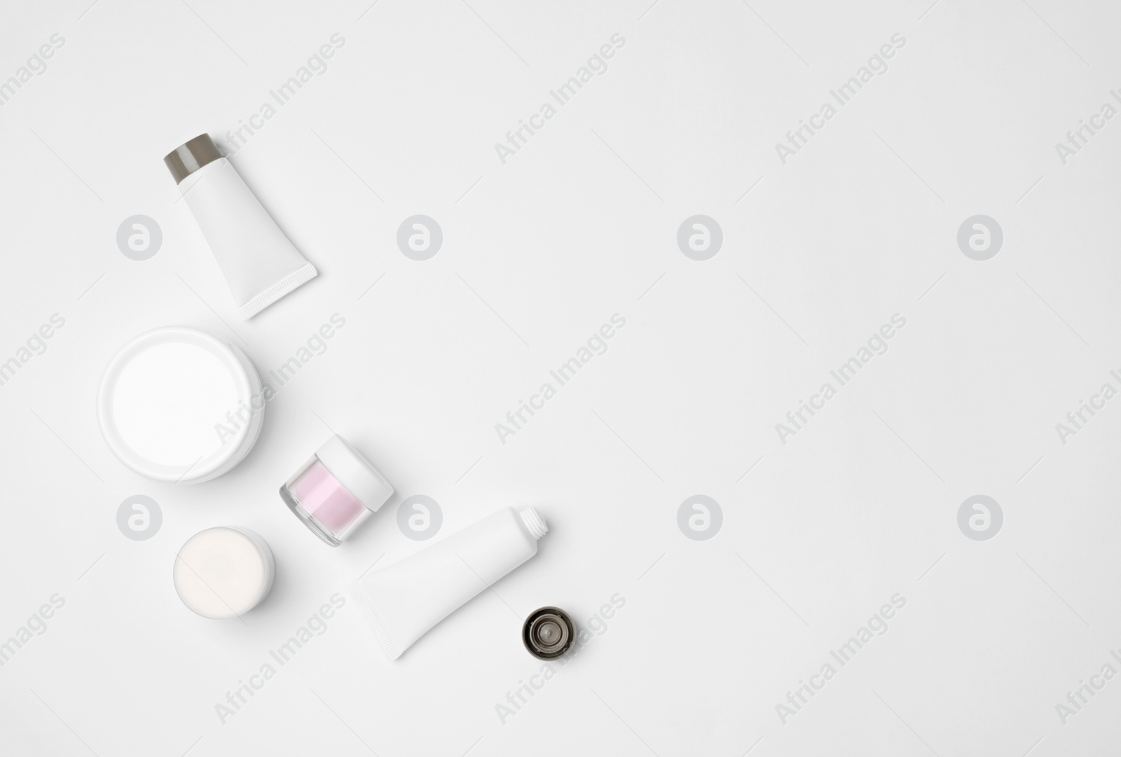 Photo of Flat lay composition with cosmetic products on light background