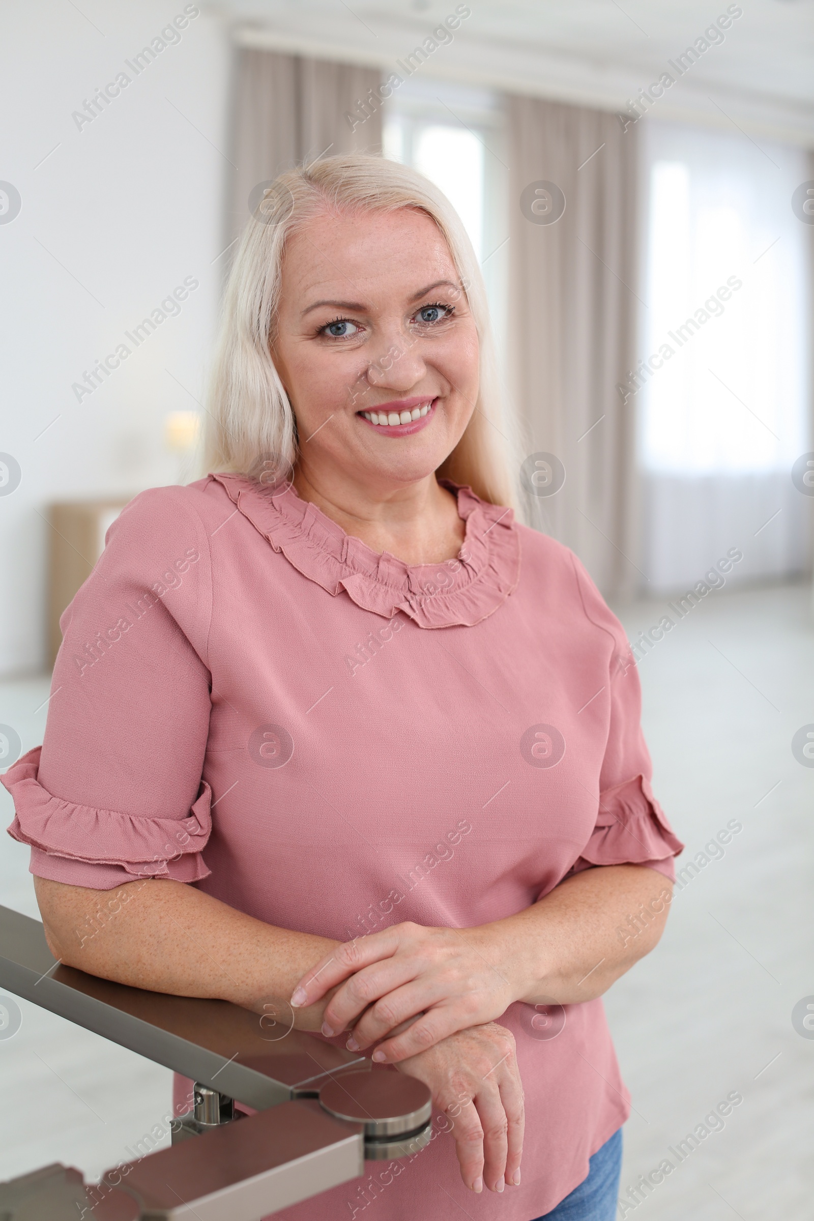 Photo of Portrait of beautiful older woman against blurred background