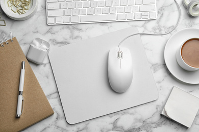 Photo of Modern workplace with mouse and keyboard on marble table, flat lay