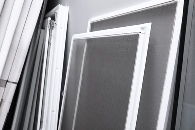 Photo of Mosquito window screens near grey wall, closeup