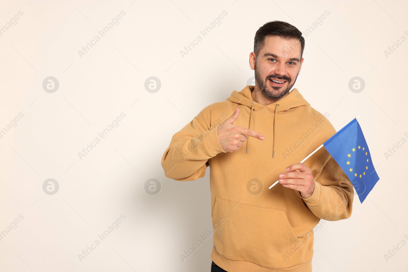 Photo of Man with flag of European Union on white background