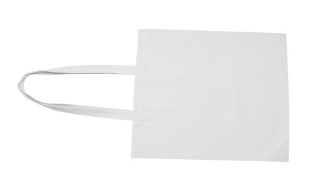 Photo of Blank beige textile bag on white background, top view. Mockup for design