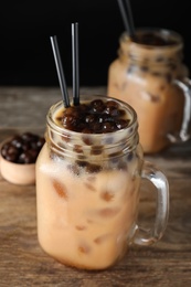 Tasty milk bubble tea on wooden table, closeup