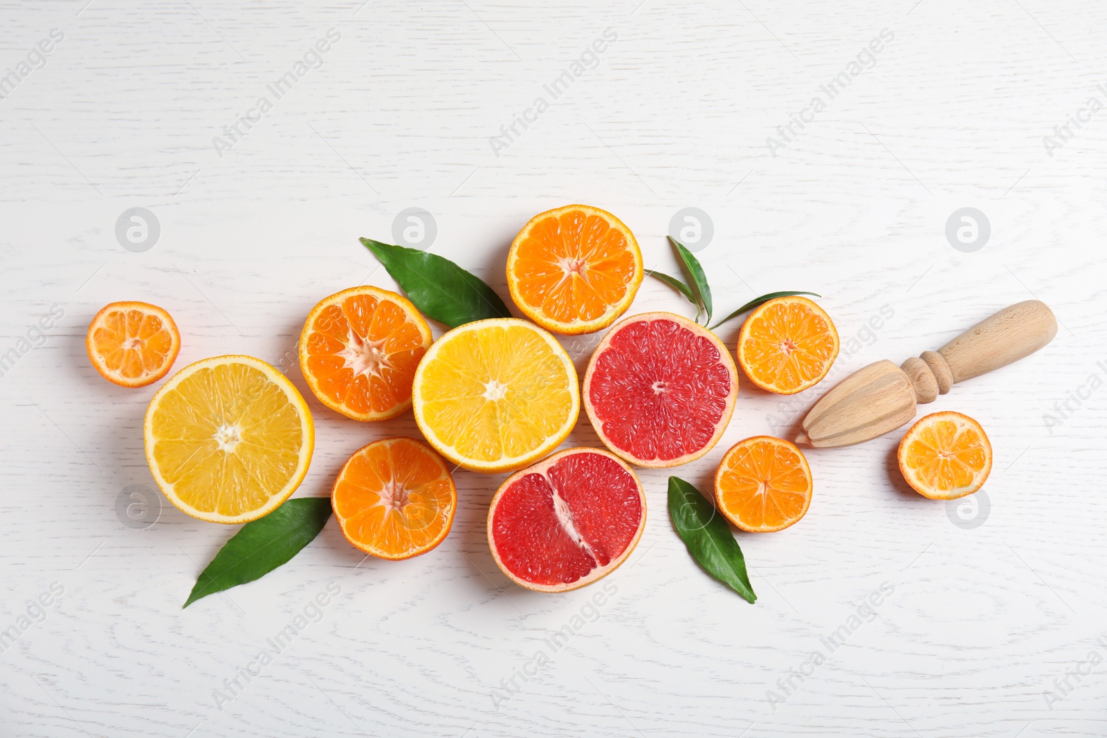 Photo of Different citrus fruits on wooden background, flat lay