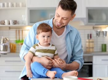 Dad and son at table in kitchen