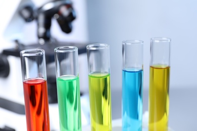 Photo of Many test tubes with samples in chemistry laboratory, closeup