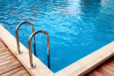 Photo of Modern swimming pool with step ladder at resort